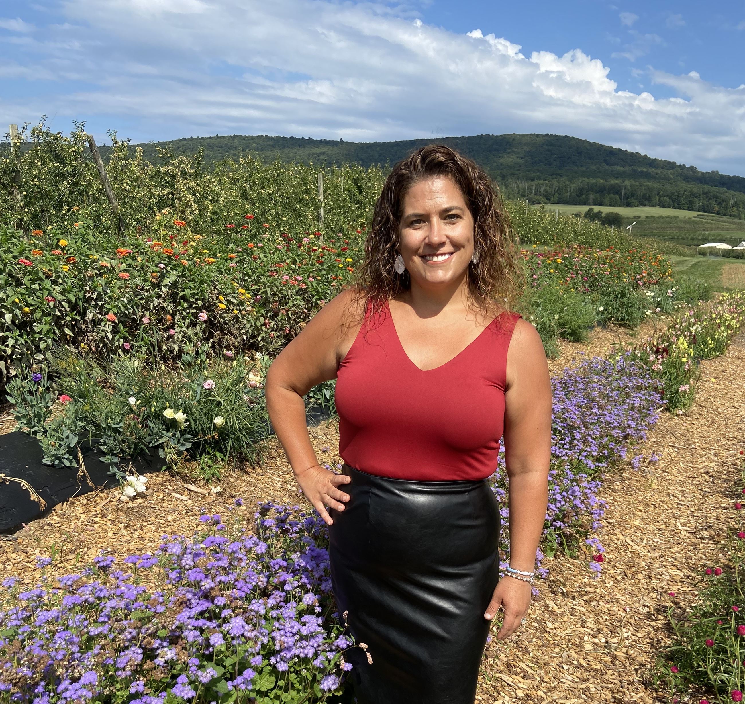 Woman standing in front of field of flowers