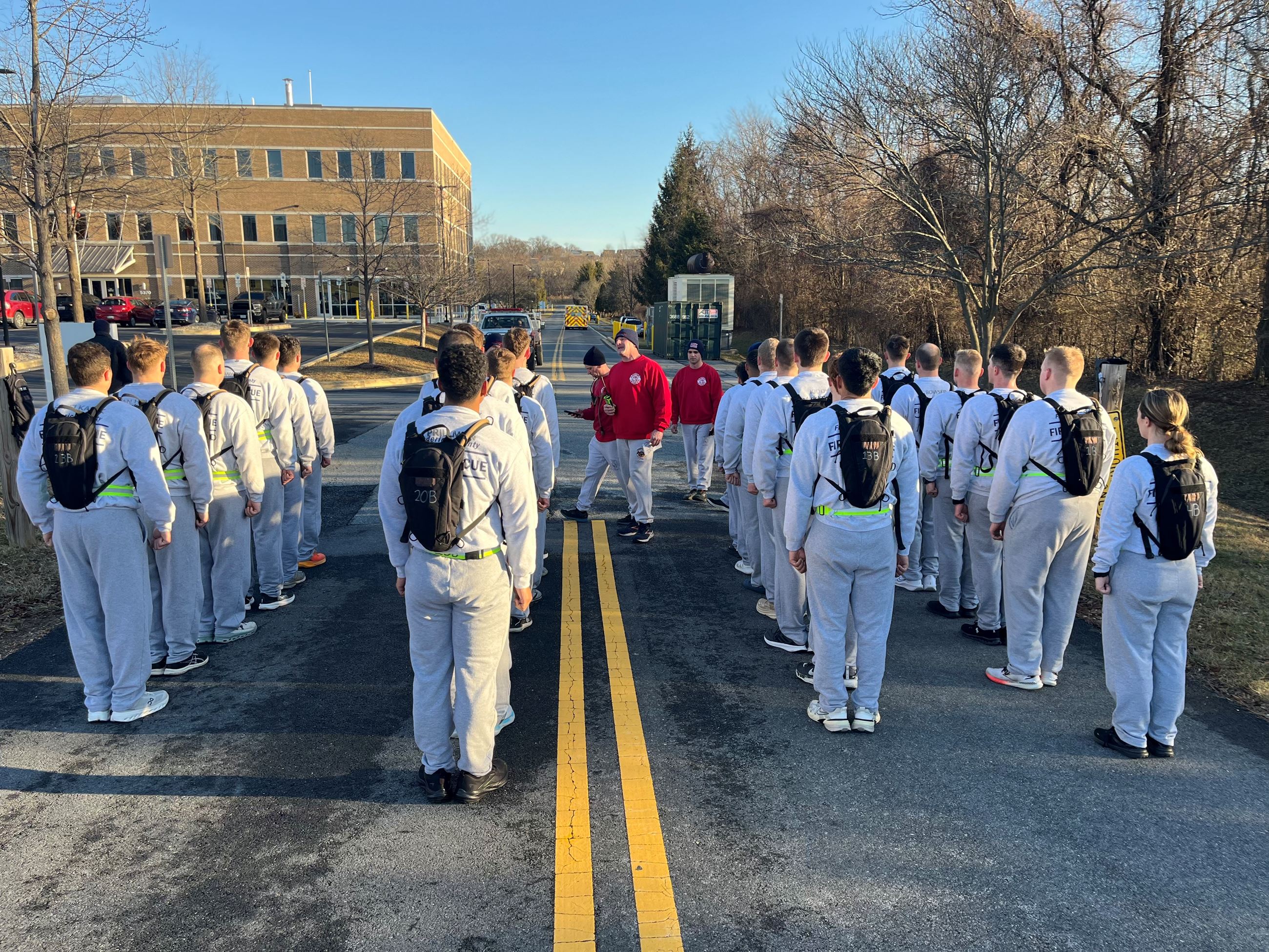 Recruits outside lined up in rows with water packs on